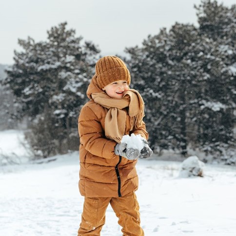 Chłopiec w brązowej zimowej kurtce 