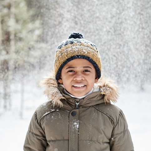 Chłopiec w zimowej zielonej kurtce 