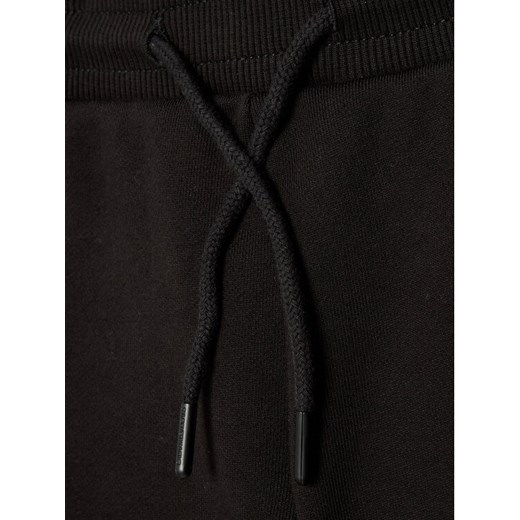 Calvin Klein Jeans Spodnie dresowe Dimension Logo IB0IB01047 Czarny Regular Fit 12Y wyprzedaż MODIVO