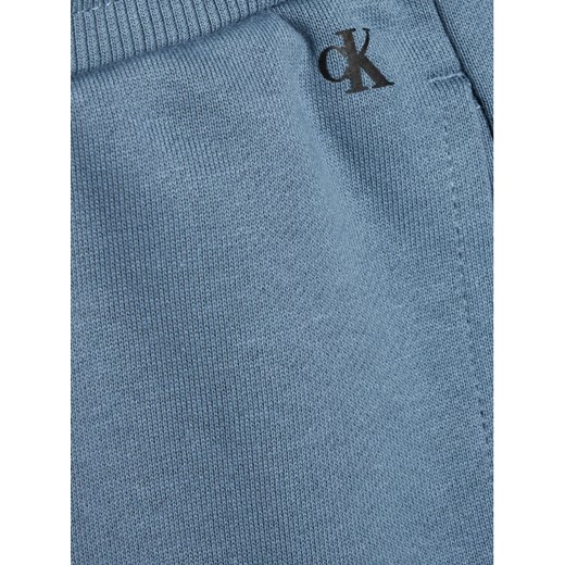 Calvin Klein Jeans Spodnie dresowe Institutional Spray IB0IB00922 Niebieski 12Y okazyjna cena MODIVO
