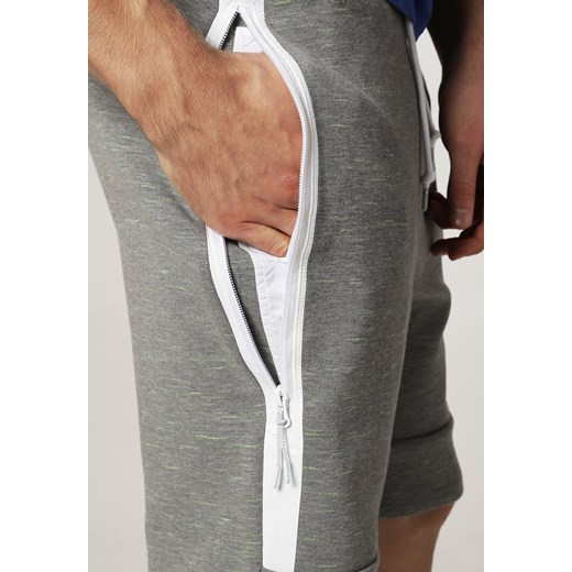 Nike Sportswear Spodnie treningowe carbon heather/white zalando pomaranczowy Spodnie