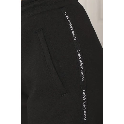 CALVIN KLEIN JEANS Spodnie dresowe LOGO PIPING | flare fit S Gomez Fashion Store okazja