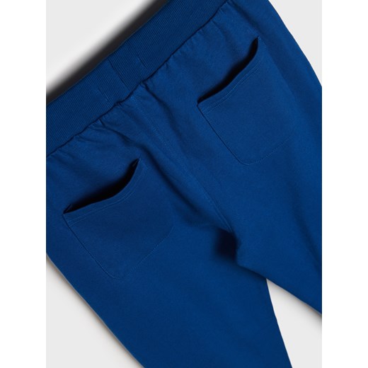 Sinsay - Spodnie dresowe jogger Grinch - niebieski Sinsay 134 Sinsay