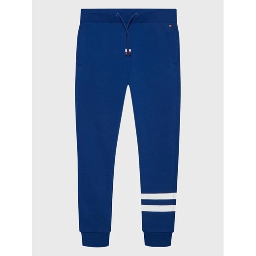 Tommy Hilfiger Spodnie dresowe Collegiate KB0KB07983 D Niebieski Regular Fit ze sklepu MODIVO w kategorii Spodnie chłopięce - zdjęcie 168448885