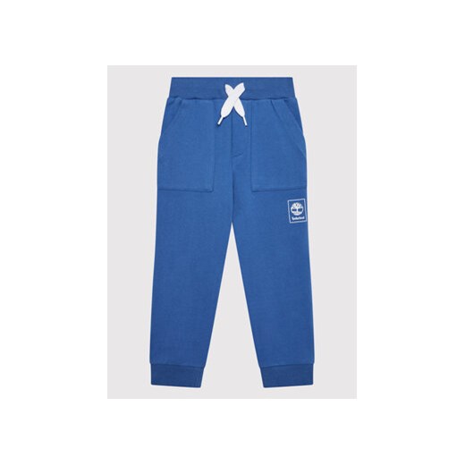 Timberland Spodnie dresowe T24B79 S Niebieski Regular Fit ze sklepu MODIVO w kategorii Spodnie chłopięce - zdjęcie 168530647