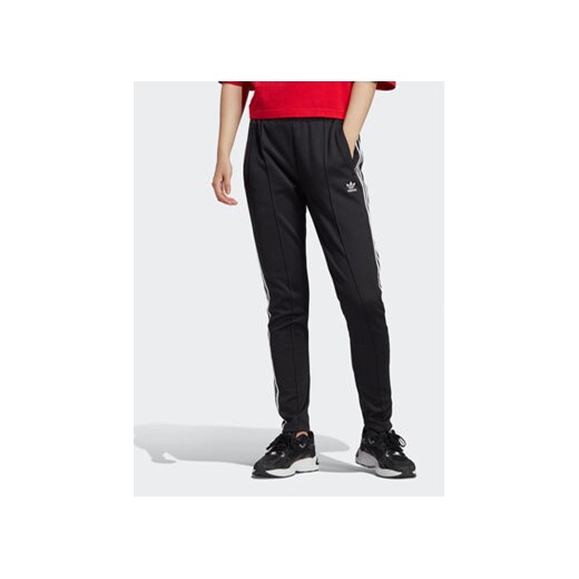 adidas Spodnie dresowe adicolor IB5916 Czarny Slim Fit ze sklepu MODIVO w kategorii Spodnie damskie - zdjęcie 168590748