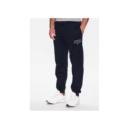 Tommy Hilfiger Spodnie dresowe UM0UM02880 Granatowy Regular Fit ze sklepu MODIVO w kategorii Spodnie męskie - zdjęcie 168621106