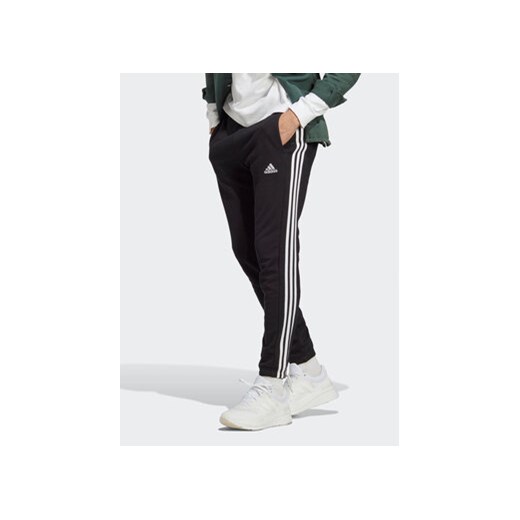 adidas Spodnie dresowe Essentials French Terry Tapered Elastic Cuff 3-Stripes Joggers IC0050 Czarny Regular Fit ze sklepu MODIVO w kategorii Spodnie męskie - zdjęcie 168665755