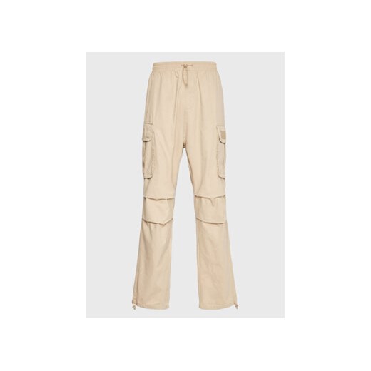 Karl Kani Spodnie materiałowe Rubber Signature 6002506 Beżowy Relaxed Fit ze sklepu MODIVO w kategorii Spodnie męskie - zdjęcie 169289106
