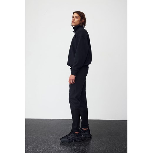 H & M - Zwężane joggersy techniczne z kieszeniami DryMove - Czarny ze sklepu H&M w kategorii Spodnie męskie - zdjęcie 169599186