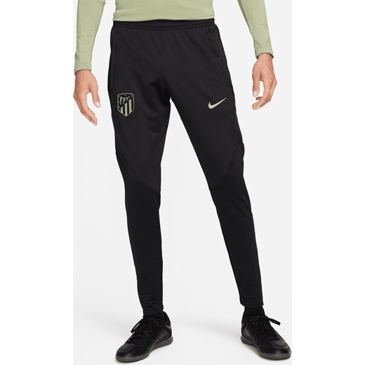 Męskie spodnie piłkarskie z dzianiny Nike Dri-FIT Atlético Madryt Strike (wersja trzecia) - Czerń ze sklepu Nike poland w kategorii Spodnie męskie - zdjęcie 169754436