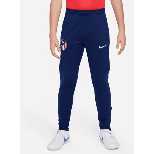 Spodnie piłkarskie z dzianiny dla dużych dzieci Atlético Madrid Strike Nike Dri-FIT - Niebieski ze sklepu Nike poland w kategorii Spodnie chłopięce - zdjęcie 169755236