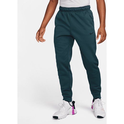 Męskie zwężane spodnie do fitnessu Therma-FIT Nike Therma - Zieleń ze sklepu Nike poland w kategorii Spodnie męskie - zdjęcie 169756638