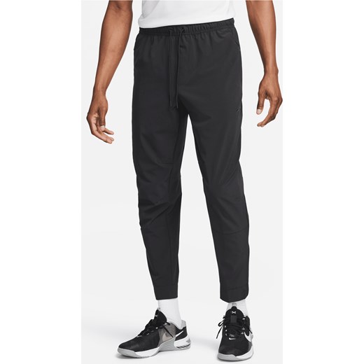 Męskie uniwersalne spodnie ze ściągaczami i zamkami Dri-FIT Nike Unlimited - Czerń ze sklepu Nike poland w kategorii Spodnie męskie - zdjęcie 169757339