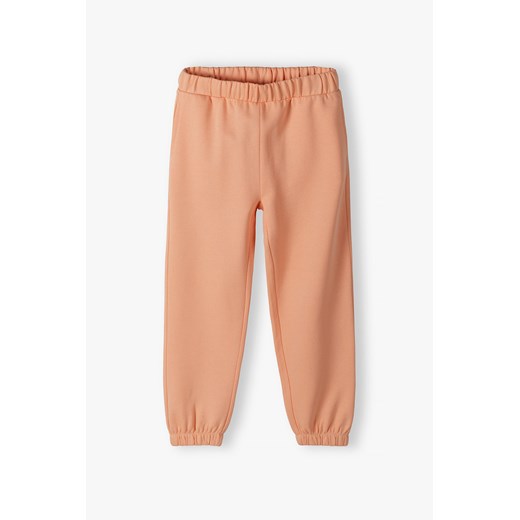 Dresowe spodnie dla dziewczynki - brzoskwiniowe - Lincoln&Sharks ze sklepu 5.10.15 w kategorii Spodnie dziewczęce - zdjęcie 170398837
