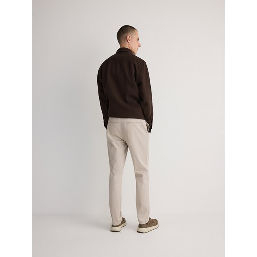 Reserved - Spodnie chino slim fit - beżowy Reserved 38 Reserved
