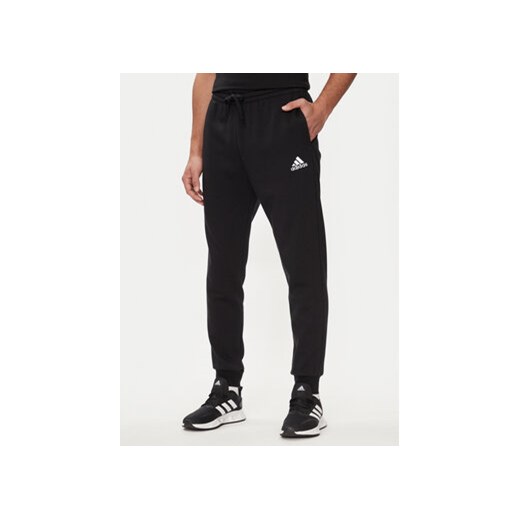 adidas Spodnie dresowe Essentials Fleece Regular Tapered Joggers HL2236 Czarny Regular Fit ze sklepu MODIVO w kategorii Spodnie męskie - zdjęcie 171413246