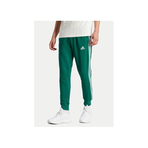 adidas Spodnie dresowe Essentials IS1392 Zielony Regular Fit ze sklepu MODIVO w kategorii Spodnie męskie - zdjęcie 171419987