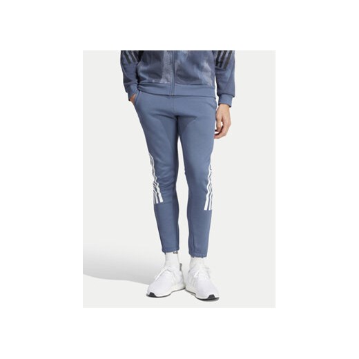 adidas Spodnie dresowe Future Icons 3-Stripes IR9194 Niebieski Slim Fit ze sklepu MODIVO w kategorii Spodnie męskie - zdjęcie 172187767