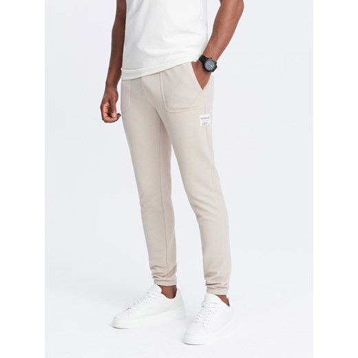 Męskie spodnie dresowe ze strukturalnej dzianiny - jasnobeżowe V1 OM-PASK-0211 ze sklepu ombre w kategorii Spodnie męskie - zdjęcie 172248657