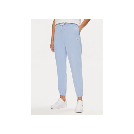 Tommy Jeans Spodnie dresowe Script DW0DW17771 Błękitny Relaxed Fit ze sklepu MODIVO w kategorii Spodnie damskie - zdjęcie 172442846