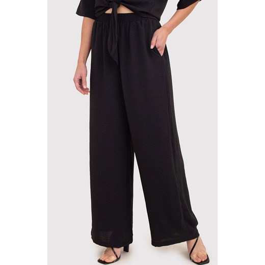 Czarne spodnie z szerokimi nogawkami i elastyczną talią TRA038, Kolor czarny, Rozmiar L, AX Paris ze sklepu Primodo w kategorii Spodnie damskie - zdjęcie 172548777