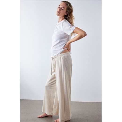 H & M - MAMA Spodnie o luźnym kroju - Beżowy ze sklepu H&M w kategorii Spodnie damskie - zdjęcie 173421398