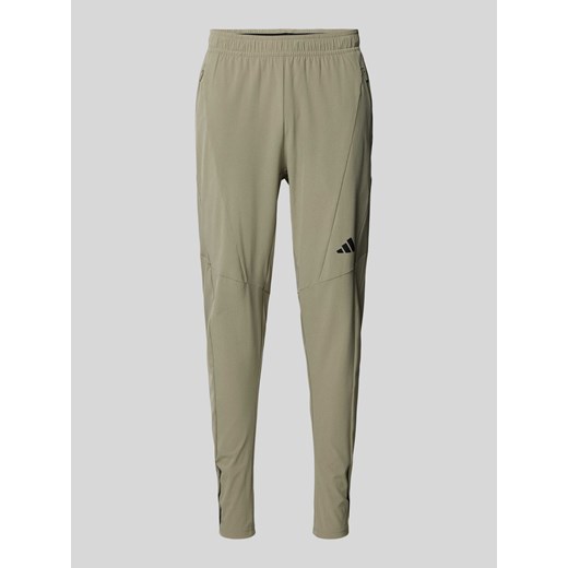 Spodnie treningowe o kroju regular fit z nadrukiem z logo ze sklepu Peek&Cloppenburg  w kategorii Spodnie męskie - zdjęcie 174573237