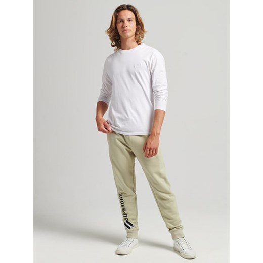 Superdry Spodnie dresowe w kolorze beżowym ze sklepu Limango Polska w kategorii Spodnie męskie - zdjęcie 175611185