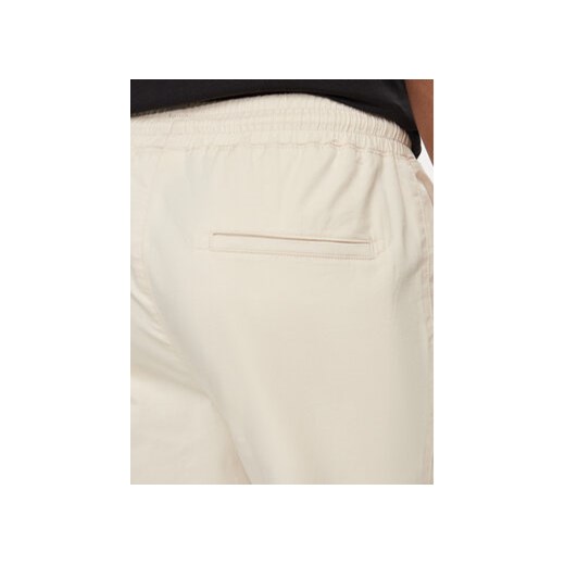 Champion Spodnie dresowe 219865 Beżowy Custom Fit Champion L MODIVO
