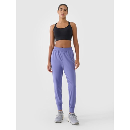 Damskie spodnie treningowe 4F 4FRSS25TFTRF0789 - niebieskie ze sklepu Sportstylestory.com w kategorii Spodnie damskie - zdjęcie 178363145
