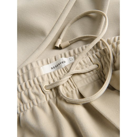 Reserved - Spodnie regular fit - złamana biel Reserved XXL Reserved