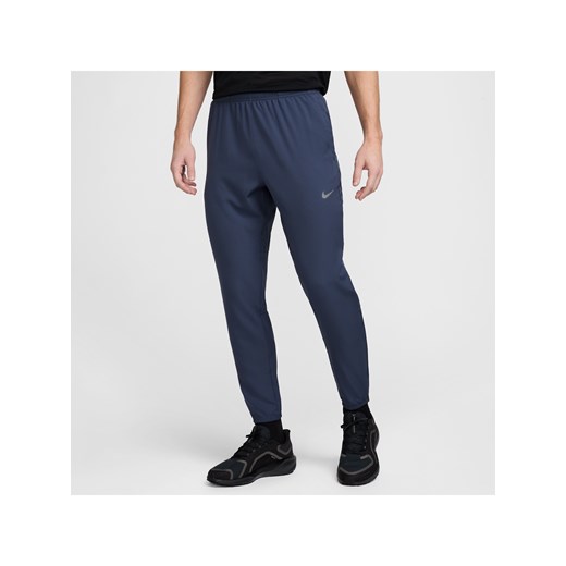 Męskie spodnie do biegania z tkaniny Dri-FIT Nike Challenger - Niebieski ze sklepu Nike poland w kategorii Spodnie męskie - zdjęcie 178602175
