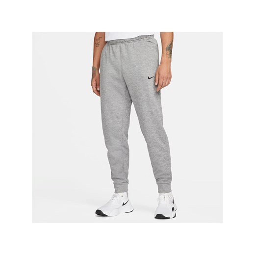 Męskie zwężane spodnie do fitnessu Therma-FIT Nike Therma - Szary ze sklepu Nike poland w kategorii Spodnie męskie - zdjęcie 178605008
