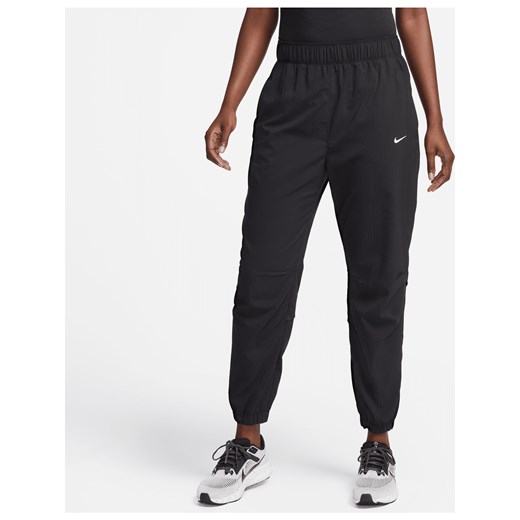 Damskie spodnie do biegania i rozgrzewki 7/8 ze średnim stanem Nike Dri-FIT Fast - Czerń ze sklepu Nike poland w kategorii Spodnie damskie - zdjęcie 178606359