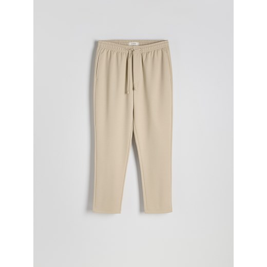 Reserved - Spodnie regular fit - złamana biel Reserved S Reserved