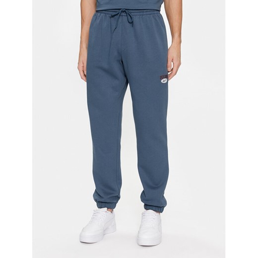 Reebok Spodnie dresowe Archive Essentials IM1526 Niebieski Regular Fit ze sklepu MODIVO w kategorii Spodnie męskie - zdjęcie 182593775