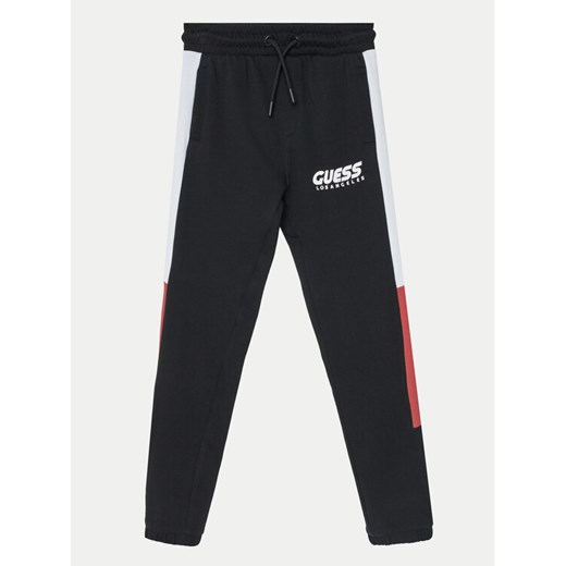 Guess Spodnie dresowe L5RQ11 KA6R4 Czarny Regular Fit ze sklepu MODIVO w kategorii Spodnie chłopięce - zdjęcie 182597267
