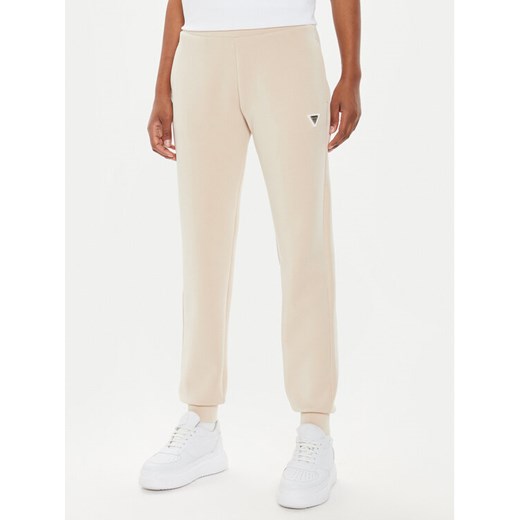 Guess Spodnie dresowe V4YB08 KCAY2 Beżowy Regular Fit ze sklepu MODIVO w kategorii Spodnie damskie - zdjęcie 182599709