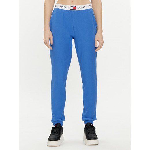 Tommy Jeans Spodnie dresowe UW0UW05154 Niebieski Regular Fit ze sklepu MODIVO w kategorii Spodnie damskie - zdjęcie 182606496