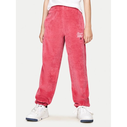 Tommy Hilfiger Spodnie dresowe Script Velour KG0KG08221 Różowy Regular Fit ze sklepu MODIVO w kategorii Spodnie dziewczęce - zdjęcie 182613299