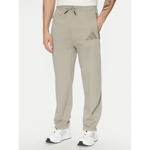 adidas Spodnie dresowe Z.N.E. Open-Hem JC6716 Beżowy Loose Fit ze sklepu MODIVO w kategorii Spodnie męskie - zdjęcie 182624647