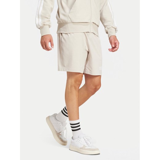 adidas Szorty sportowe Essentials Linear JC9346 Beżowy Regular Fit ze sklepu MODIVO w kategorii Spodenki męskie - zdjęcie 182625216