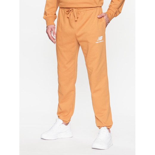 New Balance Spodnie dresowe MP31539 Żółty Regular Fit ze sklepu MODIVO w kategorii Spodnie męskie - zdjęcie 182625406