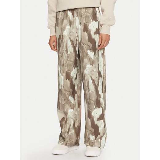 Champion Spodnie dresowe 117502 Beżowy Loose Fit ze sklepu MODIVO w kategorii Spodnie damskie - zdjęcie 182643205
