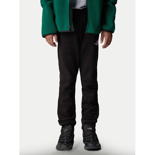 The North Face Spodnie dresowe NF0A89PD Czarny Regular Fit ze sklepu MODIVO w kategorii Spodnie chłopięce - zdjęcie 182643977