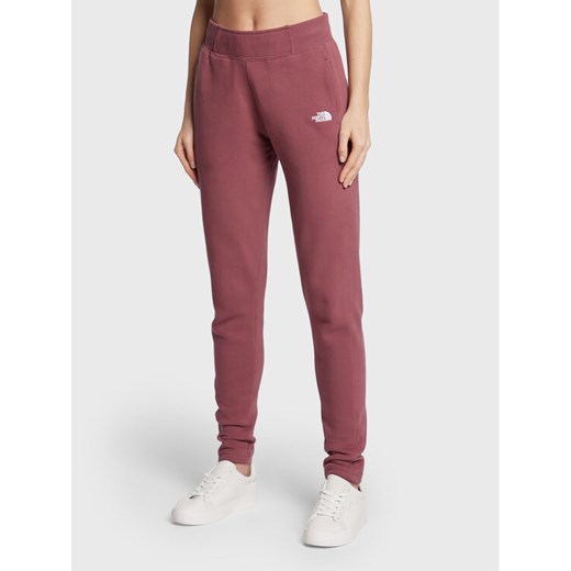 The North Face Spodnie dresowe W Nse NF0A55GS Bordowy Slim Fit ze sklepu MODIVO w kategorii Spodnie damskie - zdjęcie 182646469