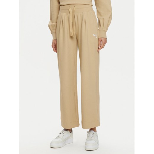 Puma Spodnie dresowe Her 676007 Beżowy Relaxed Fit ze sklepu MODIVO w kategorii Spodnie damskie - zdjęcie 182648117