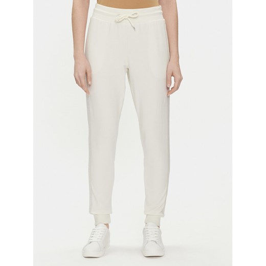 Tommy Hilfiger Spodnie dresowe UW0UW04785 Écru Regular Fit ze sklepu MODIVO w kategorii Spodnie damskie - zdjęcie 182654009