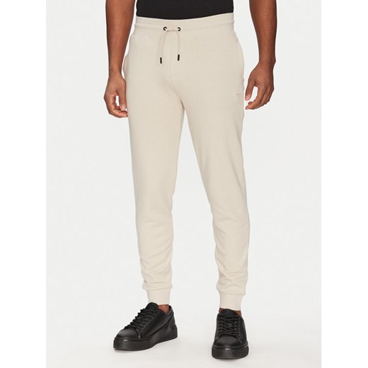 Guess Spodnie dresowe 2YB22 KAIJ1 Écru Regular Fit ze sklepu MODIVO w kategorii Spodnie męskie - zdjęcie 182654787